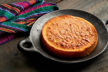 Latin sweet cheese bread dessert in a clay plate, salvadoran quesadilla
