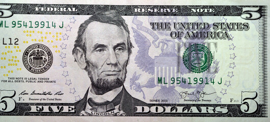 obverse side of 5 dollars portrait, five American dollars banknote background, selective focus,...
