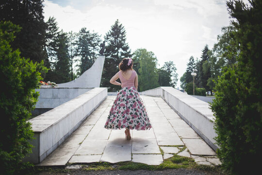 Rear View Of A Woman In A Flowy Floral Dress