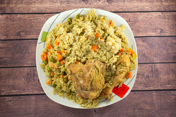 GREEN RICE WITH CHICKEN, WITH CHUNKED CARROT, GREEN PEAN AND PEPPER.
