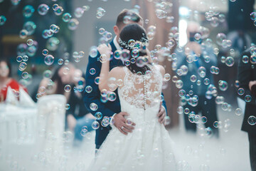 Newly married couple dancing during the wedding celebration surrounded by soap bubbles
