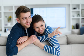 a young married couple enjoys sitting in the large living room