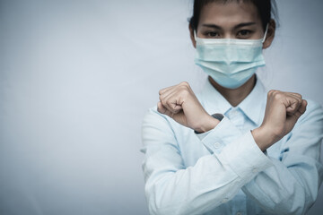 Girl wearing mask for protection from disease and show stop hands gesture for stop corona virus outbreak. Concept against coronavirus, COVID 19