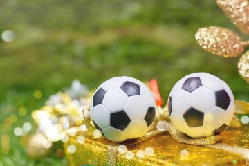 Fototapeta premium Soccer ball with Christmas decoration on green grass