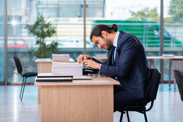 Young male employee working in the office