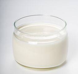 Sour cream in glass jar isolated on white background