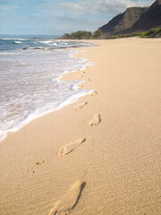 Foot prints on a sandy beach.  
