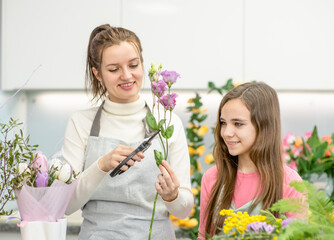 Florist girl teaches how to build a bouquet