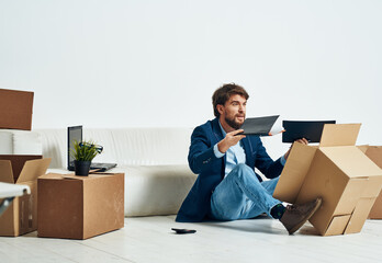 man unpacking boxes stuff office professional job official