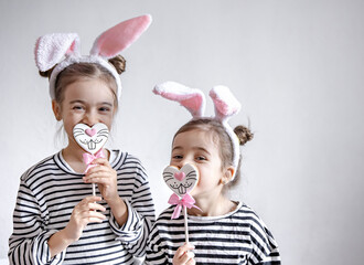 Little girls with decorative Easter bunny ears and Easter gingerbread.