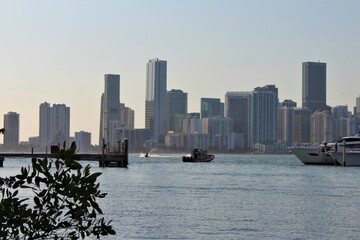 Tug boat going to save a yacht from the ocean in the Biscayne bay harbor inlet during sunset....