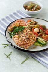 Grilled Turkey Breast with fresh salad. Bright background. 