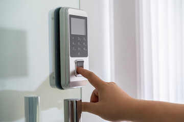 Cropped shot of hand push down electronic control machine with finger scan to access the door for security system.