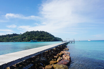 Summer landscape on tropical koh Kood island in Thailand. Landscape with long wooden pier taken on Bang Bao beach.