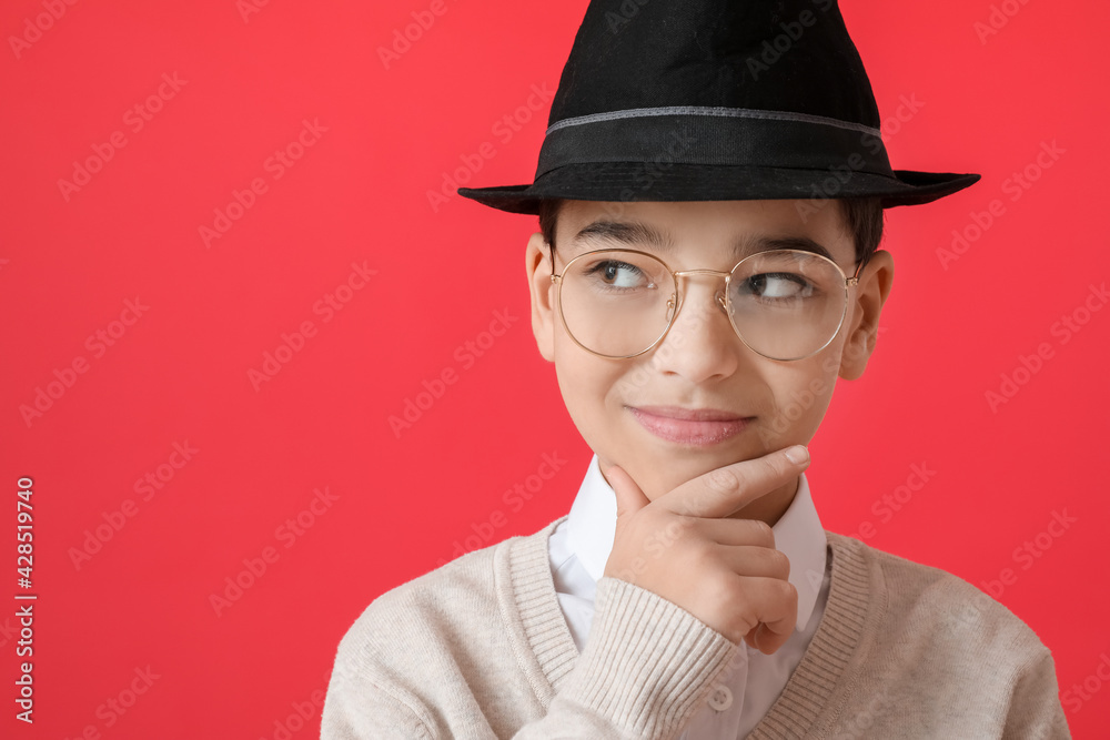 Wall mural Stylish little boy on color background