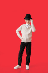 Stylish little boy on color background