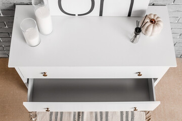 Modern chest of drawers in interior of room