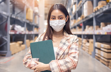 Portrait of smiling asian manager worker woman standing and order details on tablet computer for checking goods  in warehouse store .Asian owner or small business concept.