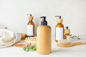 Bottle with natural shampoo on light wooden background