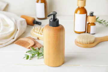 Bottle with natural shampoo on light wooden background
