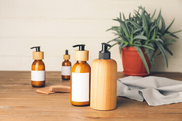 Bottles with natural shampoo on wooden background