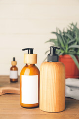 Bottles with natural shampoo on wooden background