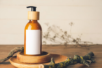 Bottle with natural shampoo on wooden background