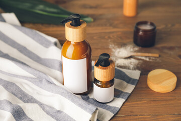 Bottles with natural shampoo on wooden background