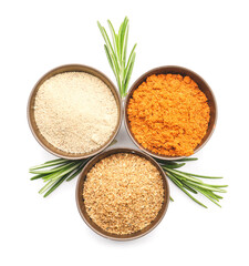 Bowls with different spices and rosemary on white background