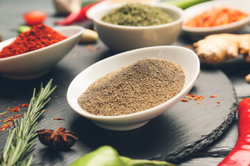 Bowls with different spices on table, closeup