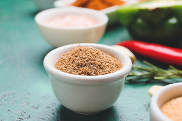 Bowls with different spices on color background, closeup