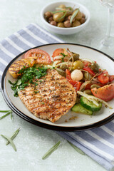 Grilled Turkey Breast with fresh salad. Bright background. 