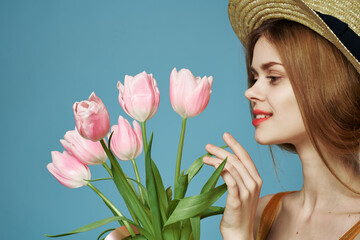 Beautiful woman elegant style hat close-up bouquet of flowers