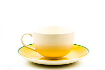 Empty white coffee cup and yellow saucer on white background.
