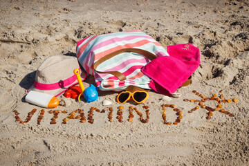 Inscription vitamin D, accessories for relax and childrens playing on sand at beach. Prevention of...