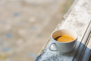 White coffee cup on natural background.