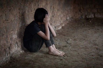 Sad child sitting in old room, Trafficking in human beings
