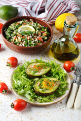 Egg baked in avocado with green salad