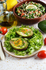 Egg baked in avocado with green salad