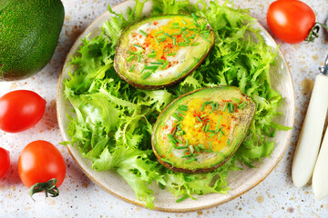 Egg baked in avocado with green salad