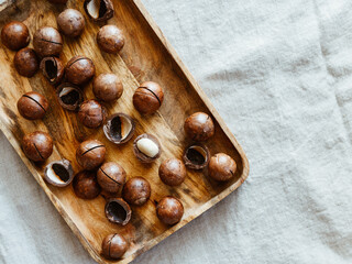 Top view of macadamia nuts on a wooden bowl