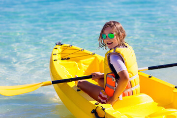 Kids kayaking in ocean. Family in kayak in tropical sea
