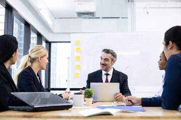 Business team and manager in meeting room.