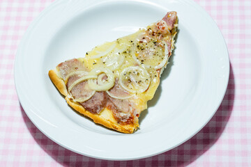 slice of pizza on a white plate