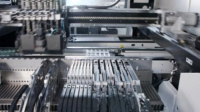 SMT machine places resistors, capacitors, transistors, LED and integrated circuits on circuit boards at high speed