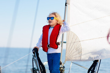 Kids sail on yacht in sea. Child sailing on boat.