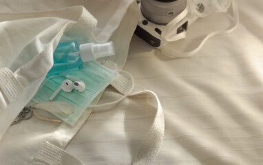 medical surgical mask and alcohol spray with white cotton bag.