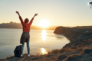 Fototapeta premium woman tourist with hands raised up freedom fresh air travel