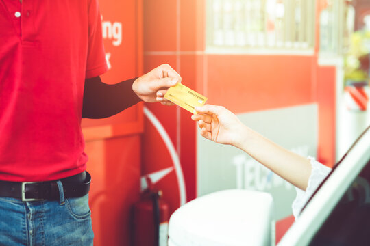 Happy Women Driver Customer Giving Credit Card Money Payment To Staff For Fuel Cost At Gas Station Or Service Fee At Garage