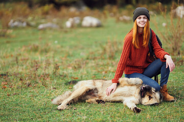 woman hiker playing with dog in nature fresh air travel